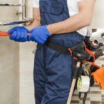 crop-plumber-using-wrench_23-2147772228